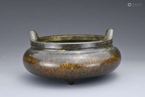 A CHINESE BRONZE TRIPOD CENSER. Of rounded form on three con...