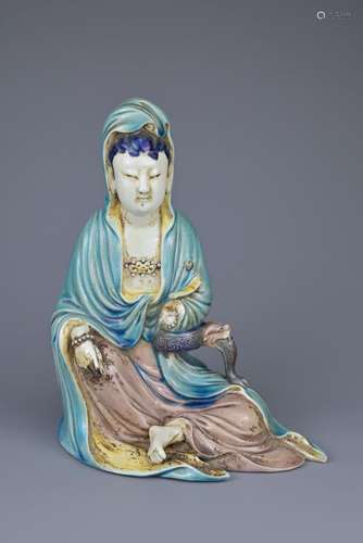 A CHINESE PORCELAIN FIGURE OF GUANYIN, 19TH CENTURY. Glazed ...