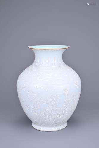 A CHINESE WHITE ENAMELLED DRAGON JAR. Decorated to the body ...