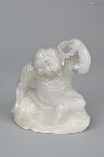 A CHINESE GREYISH WHITE JADE CARVING OF MAN AND LION DOG. Th...