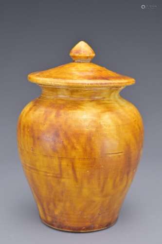A CHINESE AMBER-GLAZED POTTERY JAR AND COVER. Of baluster fo...