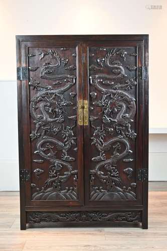 A CHINESE CARVED HARDWOOD CABINET, 20TH CENTURY. Of rectangu...