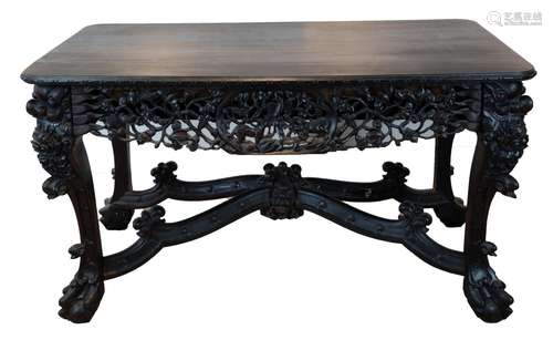 A CHINESE HEAVILY CARVED HARDWOOD TABLE, 19/20TH CENTURY. Of...