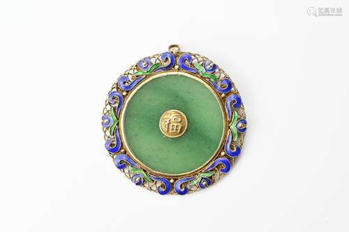 A CHINESE GILT METAL AND JADE DISC PENDANT. A circular jade ...