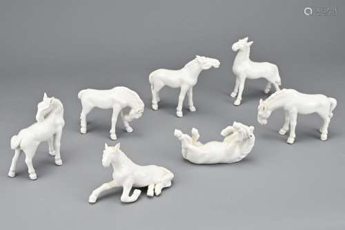 A GROUP OF SEVEN VINTAGE WHITE GLAZED PORCELAIN HORSES. In v...