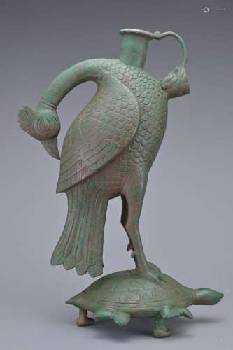 A BRONZE PHOENIX AND TURTLE TRIPOD EWER. In the form of a ph...