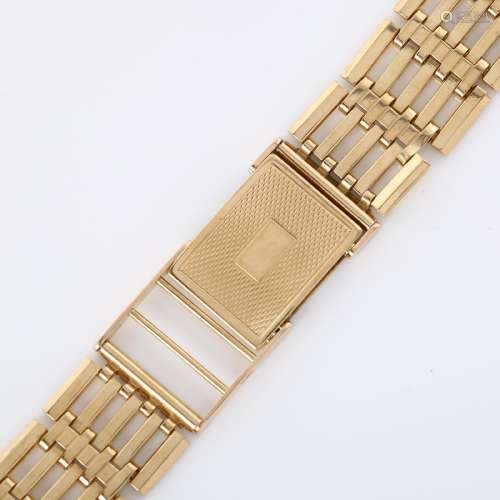 A 9ct gold gatelink watch bracelet, with engine turned clasp...