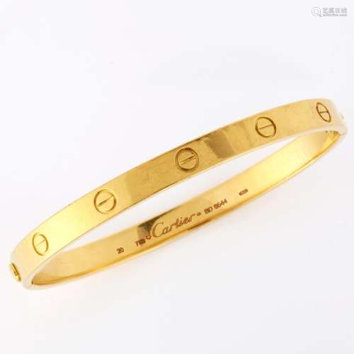 CARTIER - an 18ct gold `LOVE` bangle, with screw-head motifs...