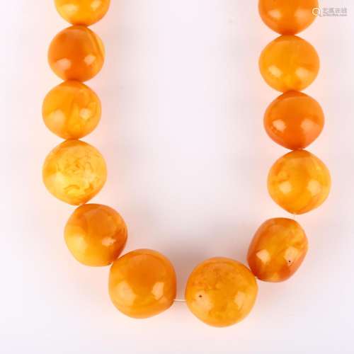 A graduated single-strand butterscotch amber bead necklace, ...