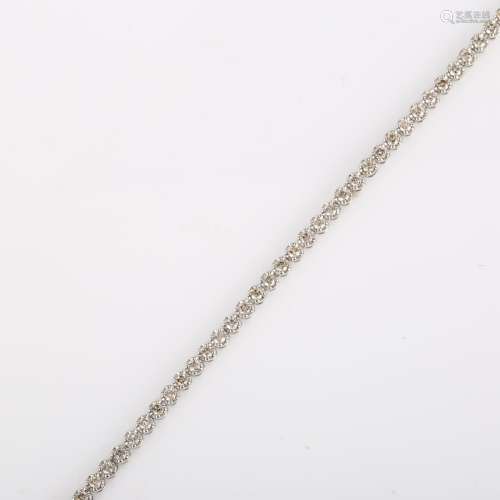 A modern 18ct white gold diamond tennis line bracelet, set w...