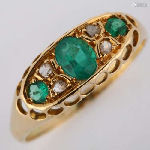 An early 20th century 18ct gold emerald and diamond half hoo...