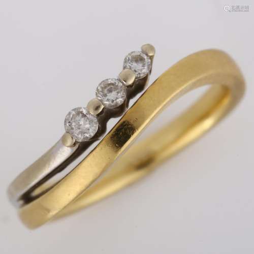 An 18ct two-colour gold three stone diamond band ring, set w...