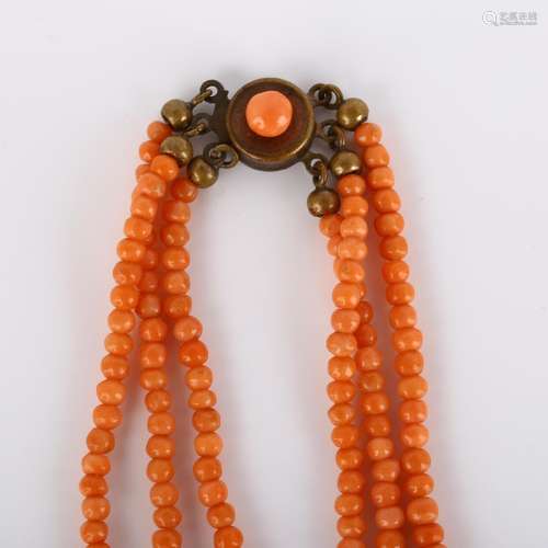 A triple-strand graduated coral bead necklace, with gilt-met...