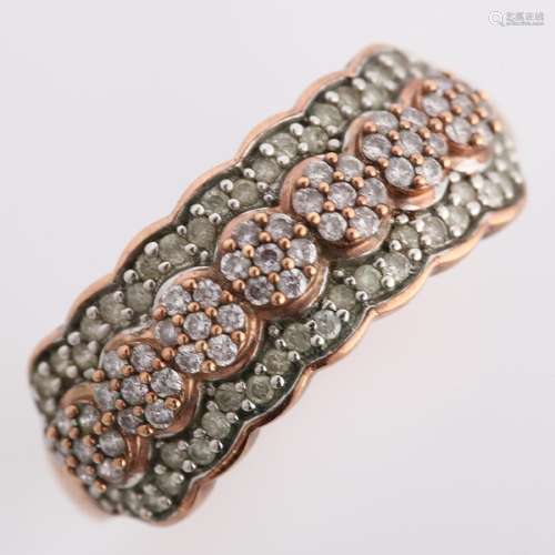 A modern 9ct rose gold diamond cluster band ring, set with m...