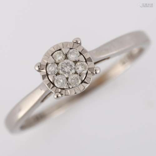 A modern 9ct white gold diamond cluster ring, illusion set w...