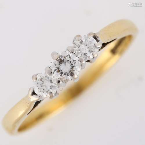 An 18ct gold three stone diamond ring, set with modern round...