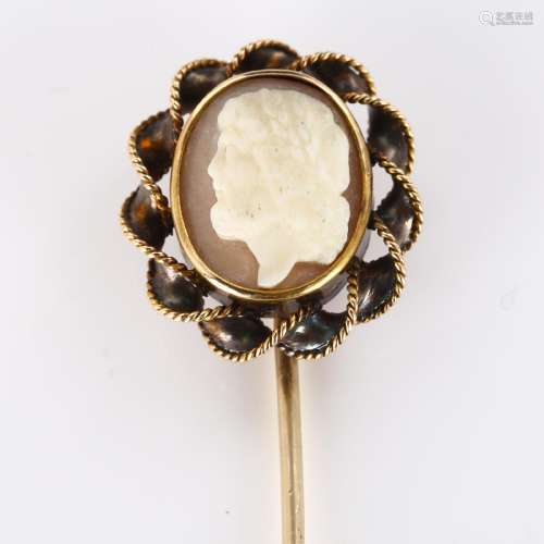 A shell cameo stickpin, unmarked gold rope twist settings, w...