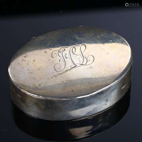 A George V silver snuffbox, plain oval form with gilt interi...