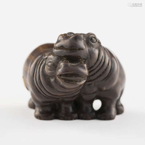 A Japanese carved wood netsuke of two hippos