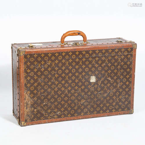 A medium Louis Vuitton monogrammed canvas hard-sided suitcas...
