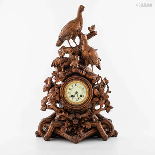 A carved oak Black Forest clock, late 19th century