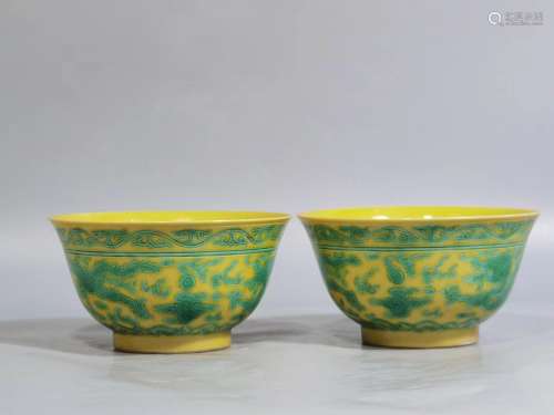 Pair of yellow-glazed and green-colored dragon bowls