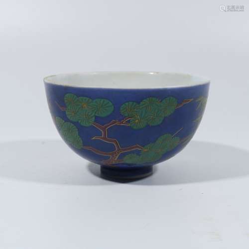Red and green plum blossom bowl on blue background