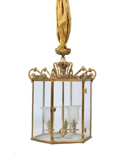 A GILT METAL AND EIGHT GLASS HALL LANTERN IN THE REGENCY STY...