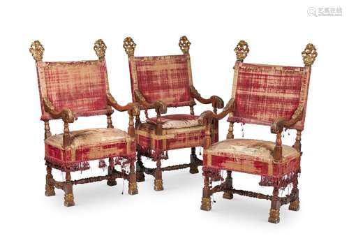 A SET OF THREE ITALIAN WALNUT AND PARCEL GILT ARMCHAIRS, LAT...