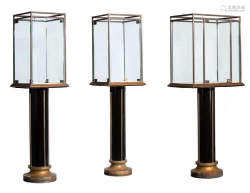 A set of three large display cabinets in brass, glass and wo...