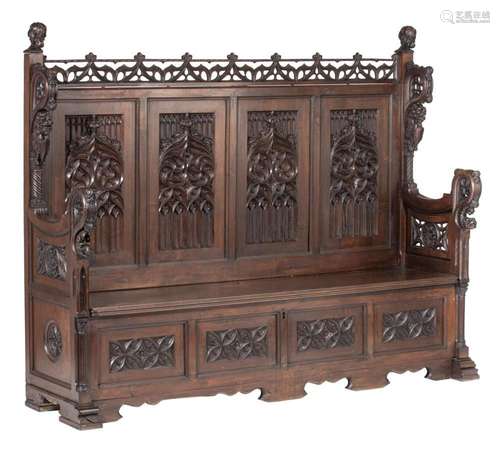 An impressive Gothic Revival richly carved walnut hall bench...