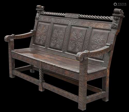 A VICTORIAN CARVED OAK SETTLE