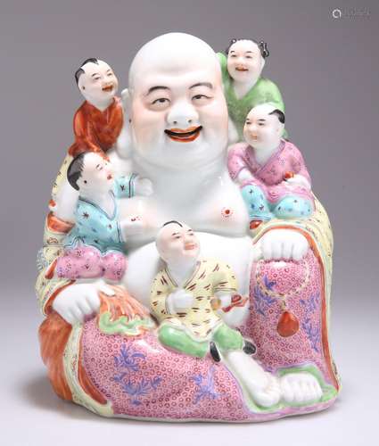 A CHINESE FAMILLE ROSE FIGURE OF A LAUGHING BUDDHA AND CHILD...