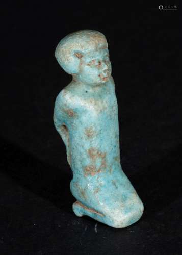 AN EGYPTIAN FAIENCE AMULET OF A PRISONER, PTOLEMAIC PERIOD C...