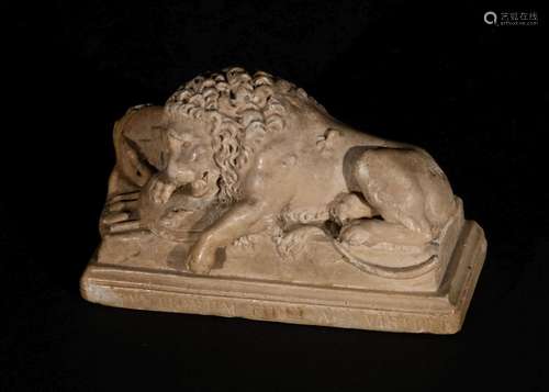 A MEDIEVAL SCULPTURE OF A RECLINING LION