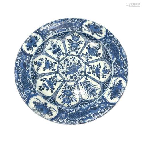 A blue and white large plate, the central roundels in the sh...