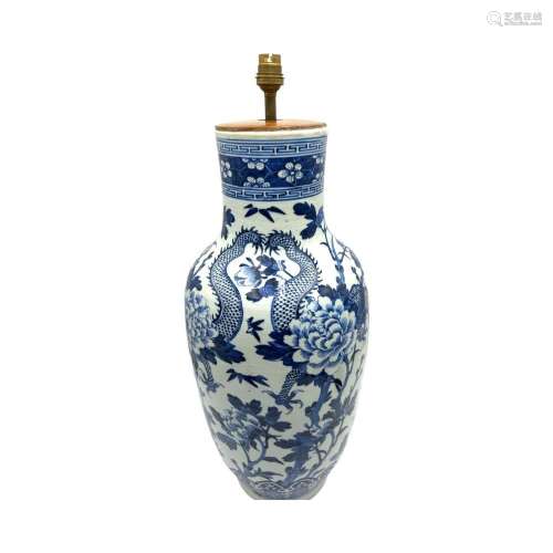 A blue and white vase, decorated with dragons amongst flower...