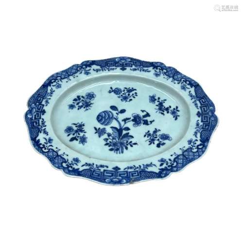 A blue and white serving plate, decorated with flower sprays...