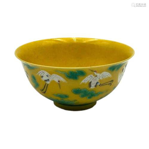 A Chinese yellow ground bowl, enamelled with white cranes am...