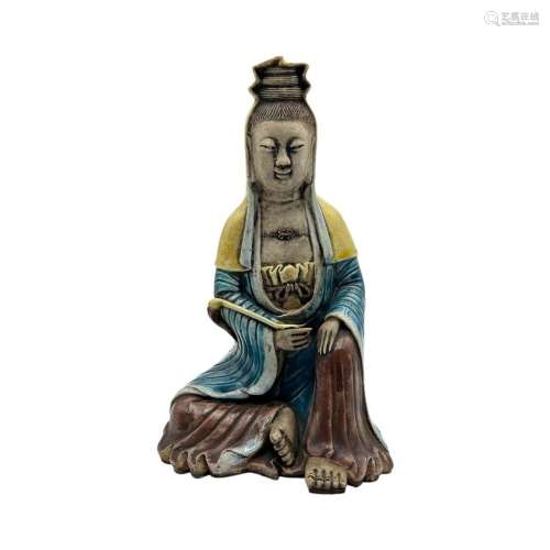 A Chinese polychrome glazed biscuit figure of the seated Gua...
