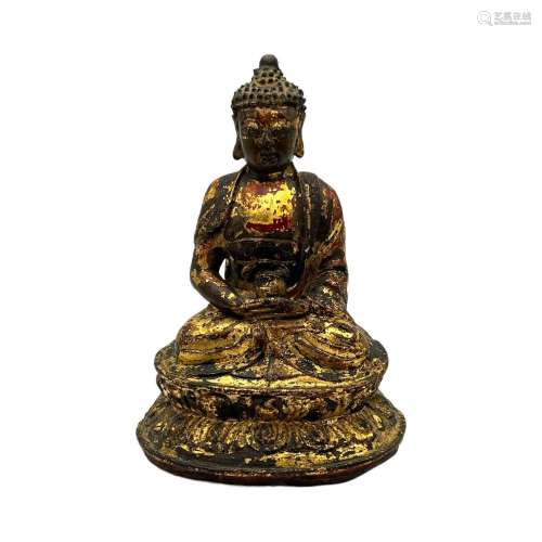 A Chinese gilt lacquered bronze figure of the seated Buddha,...