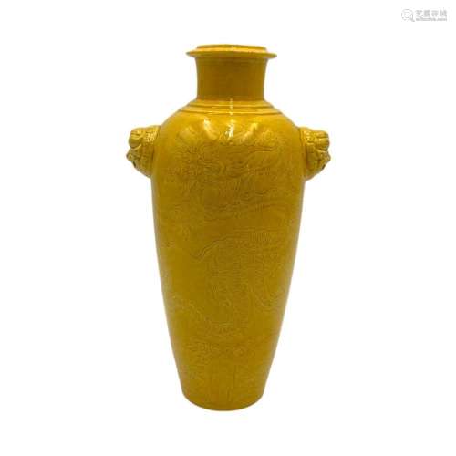 A monochrome yellow glazed vase, paired with lion head handl...