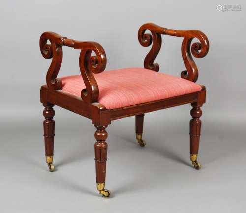 A William IV mahogany window seat with scrollwork arms and a...