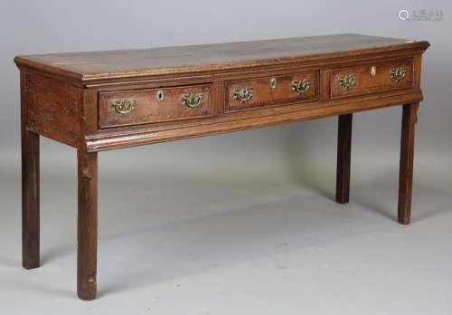 An early 18th century provincial oak dresser base, the three...