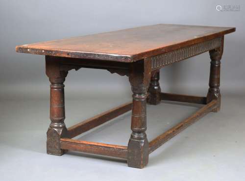 A 17th century oak refectory table, the three-plank top rais...