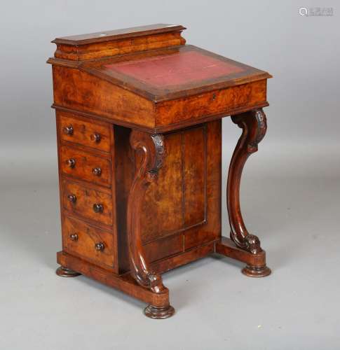 A mid-Victorian walnut Davenport, fitted with four side draw...