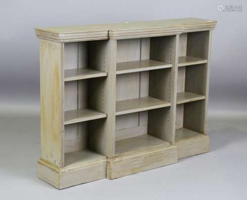 An early 20th century green painted breakfront open bookcase...