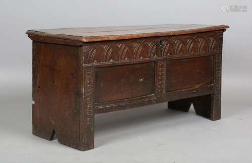 A late 17th century oak panelled and boarded coffer, the fro...