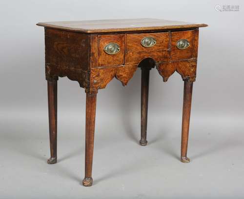 An 18th century and later elm lowboy, fitted with frieze dra...