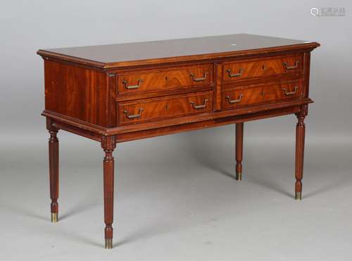 A late 20th century reproduction mahogany side table, fitted...